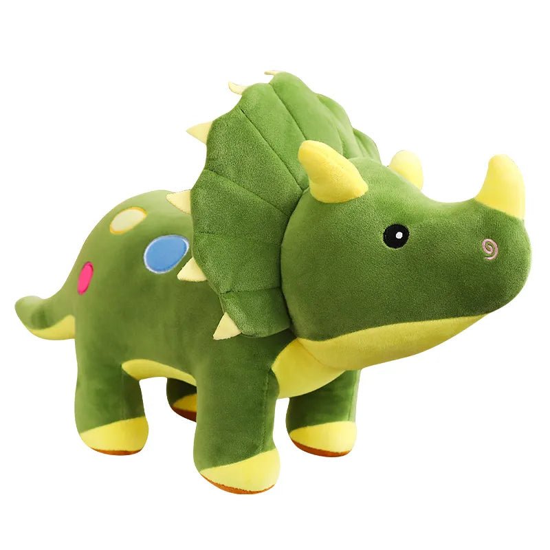 Green plush dinosaur toy with yellow horns on a white background