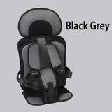 Black and grey child safety seat on a light gray background