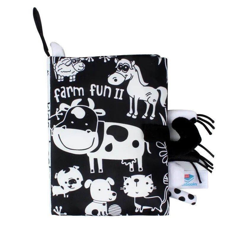 Black and white patterned book with farm animal designs and a matching bag on a white background