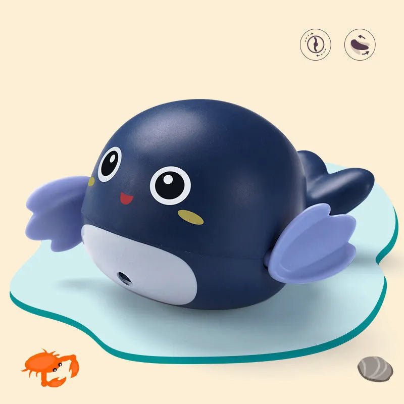 Blue whale-shaped bath toy with a suction cup on a beige background