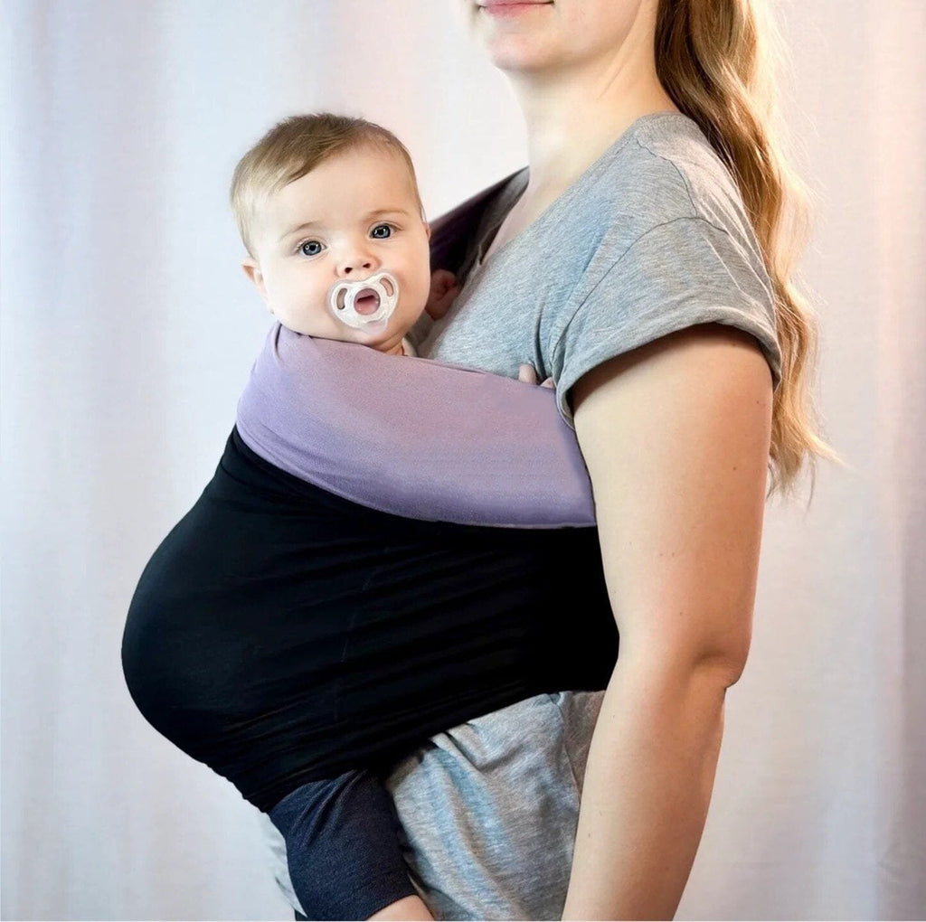 Woman holding a baby in a carrier 