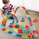 Child playing with a colorful toy track set on a wooden floor.