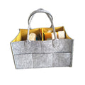 Gray felt tote bag with yellow interior holding various items 