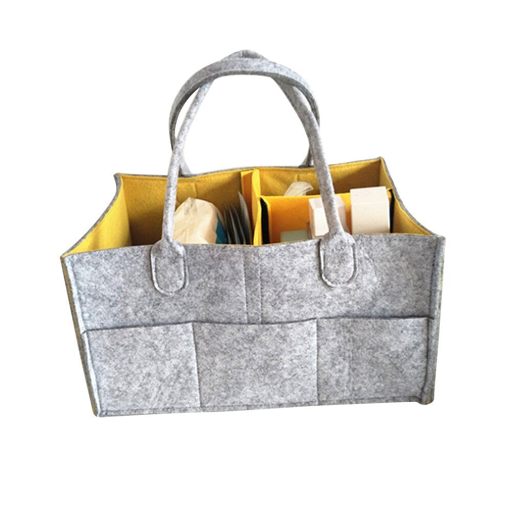 Gray felt tote bag with yellow interior, containing books and stationery items