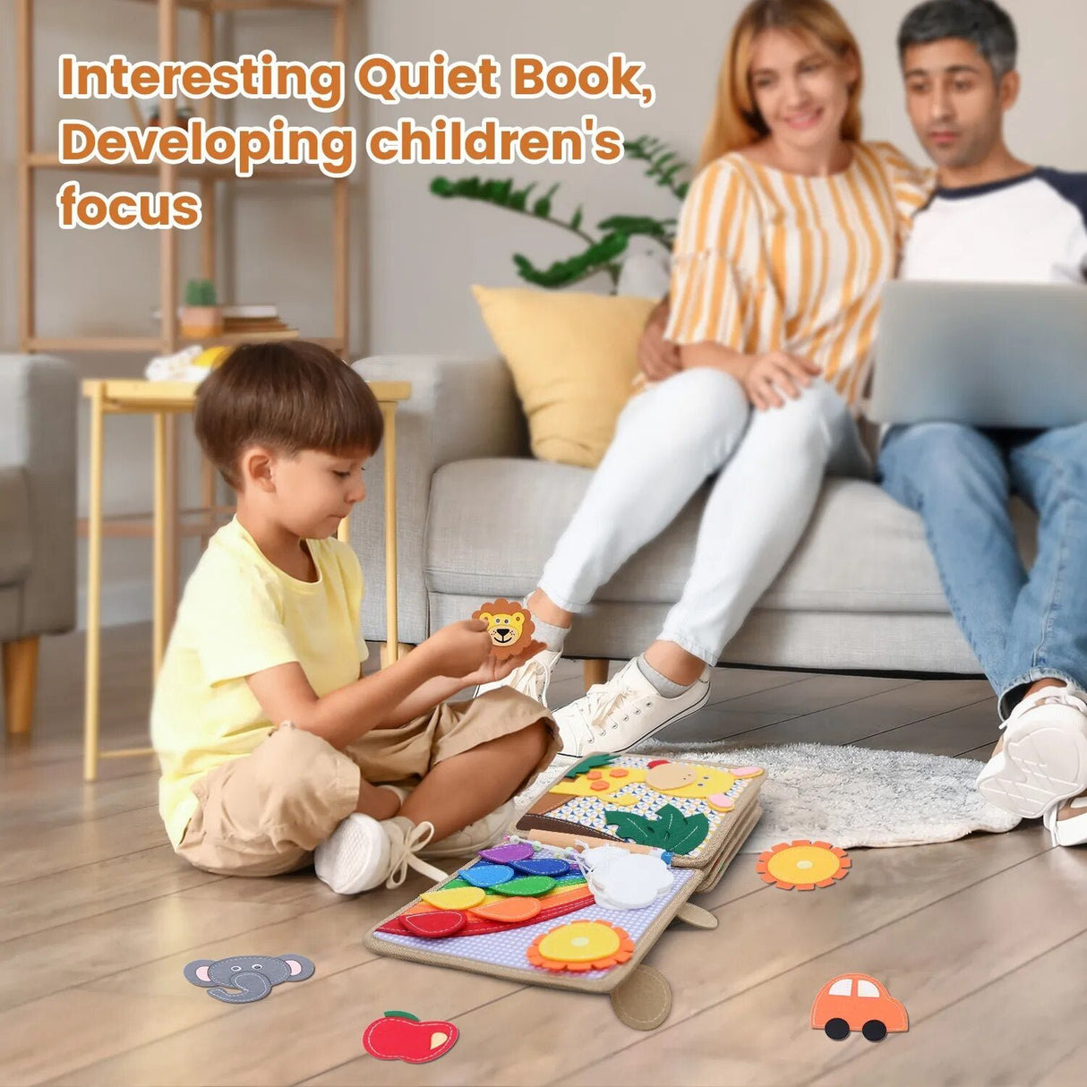 Child playing with a Quiet Book on the floor, parents sitting on a couch using a laptop.
