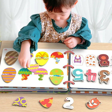 Child playing with colorful magnetic letters and shapes on a wooden table.