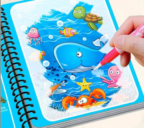 Children's activity book with ocean-themed stickers and a hand using a marker.