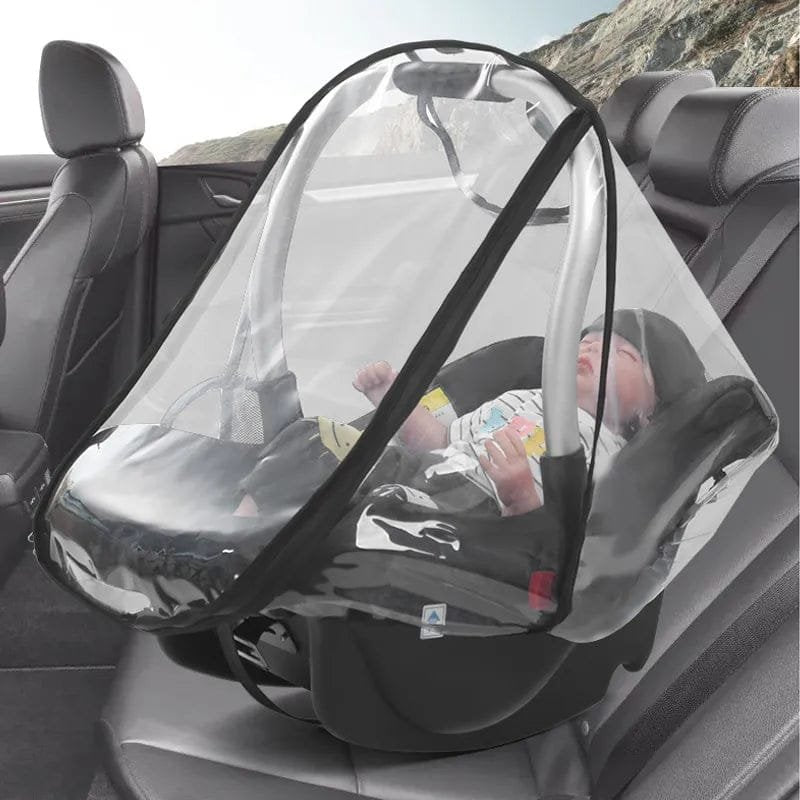 Baby in a car seat with a clear mesh cover for protection, inside a vehicle.