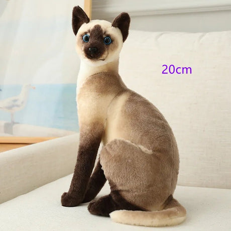 Plush toy cat sitting on a surface 