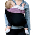A person using a baby carrier with a baby.