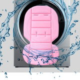Pink car seat cover with water splashes around a washing machine, symbolizing cleaning.