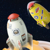Toy rocket ship with space-themed stickers against a starry space.