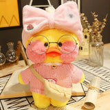 Plush toy duck wearing a pink outfit, glasses, and a bow hat on a decorative surface.