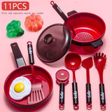 Set of red and black kitchen utensils including pots, pans, and spoons.