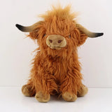 Plush toy highland cow with a fluffy brown coat.