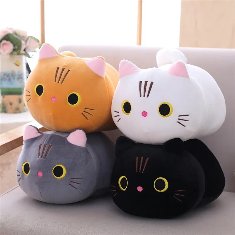 Four colorful cat-shaped cushions stacked on a surface.