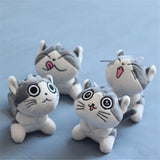 Four plush cat toys with cartoon faces