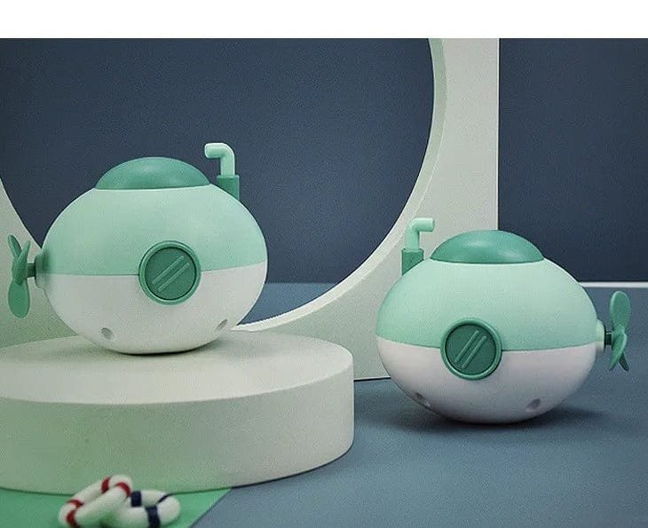 Two green and white toy submarines.