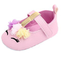 Pink baby shoe with floral decorations 