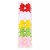 Set of colorful hair bows in a clear package