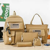 Set of beige bags including a backpack, handbag, pouch, and drawstring bag on a light surface with 'GOOSE' branding in the background.