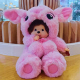 Pink plush toy with a small doll inside on a wooden surface