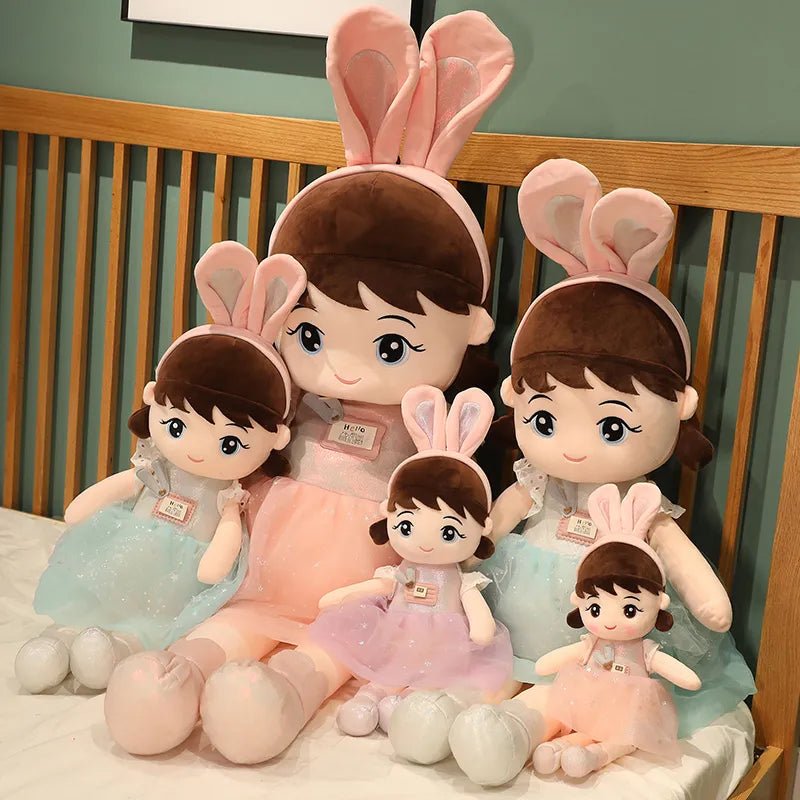Set of plush toys with bunny ears on a wooden surface