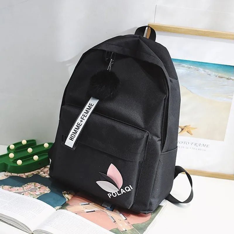 Black backpack with visible branding on a magazine background