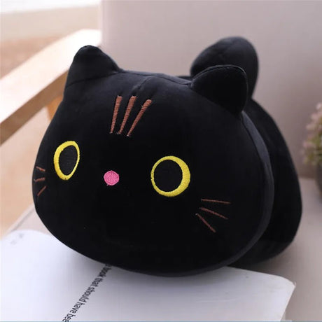 Black cat-shaped plush toy on a surface