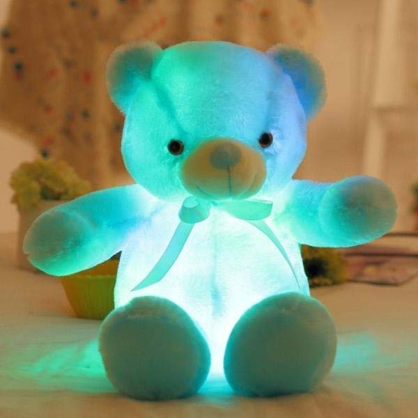 Glowing teddy bear on a soft surface.