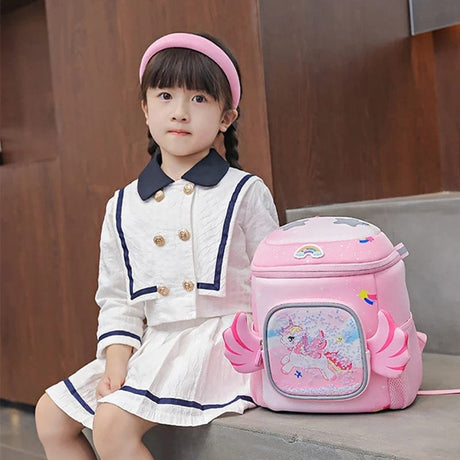 Child in a white outfit with a pink backpack featuring cartoon characters.