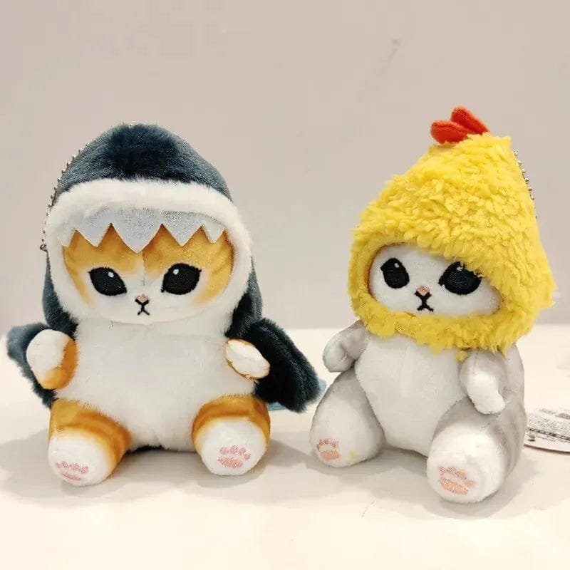 Two plush toys, one resembling a shark and the other a chicken.