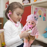 Child playing with a doll using a stethoscope in a classroom setting
