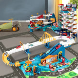Toy car track set with multiple tracks, cars, and a garage on a road layout.
