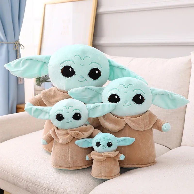 Set of four Baby Yoda plush toys on a white couch