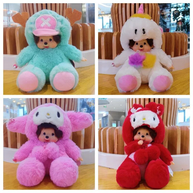 Four plush toys in different colors on a wooden table.