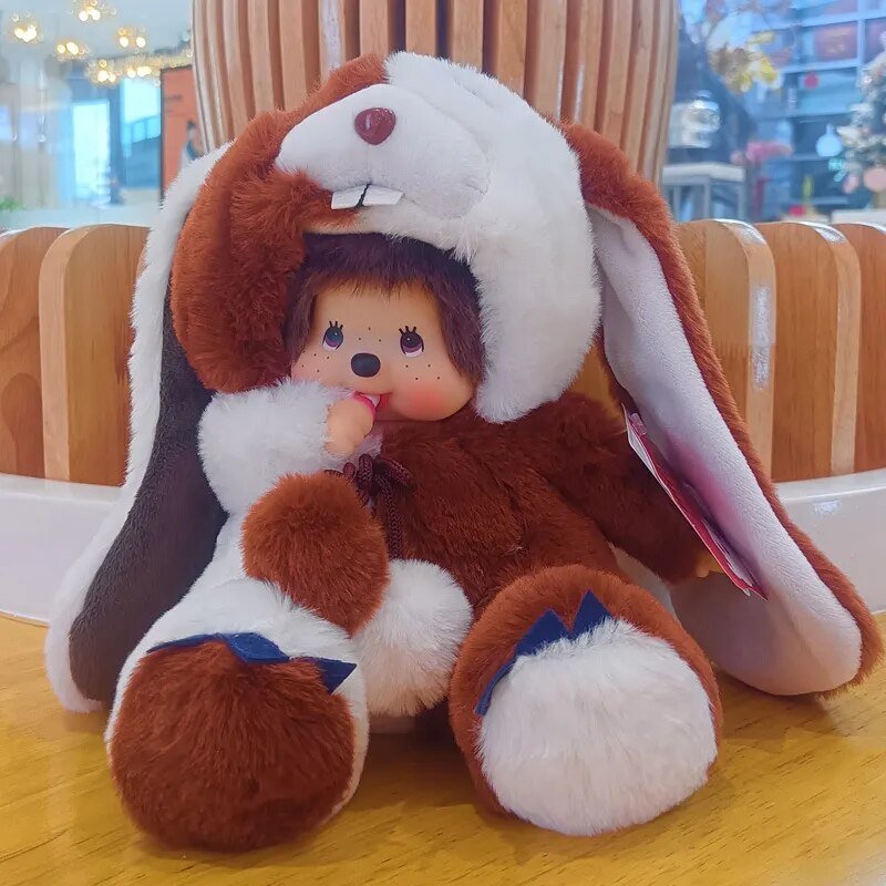 Plush toy resembling a rabbit with a small doll inside.