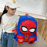 Child holding a Spider-Man backpack indoors