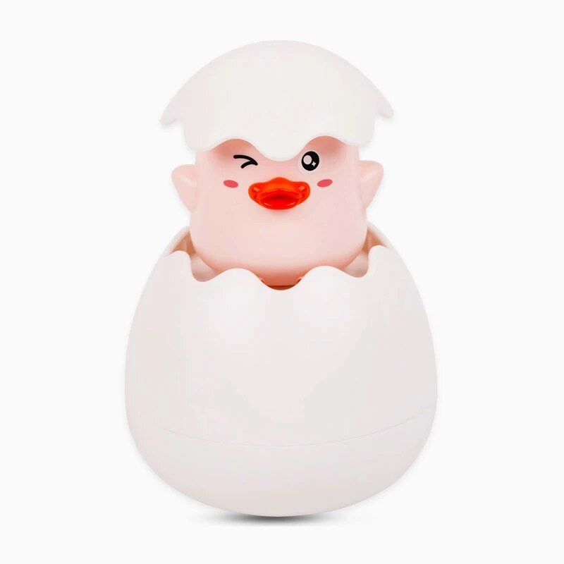 Toy duckling emerging from a white egg.