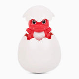 Red dinosaur toy emerging from a white egg.