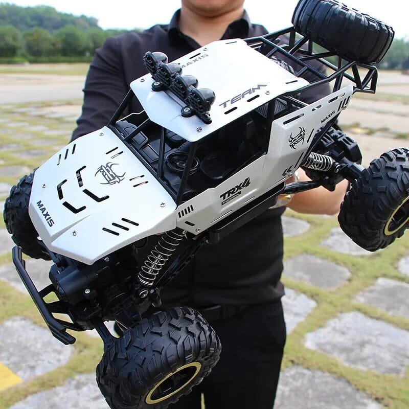 Person holding a large off-road model vehicle with detailed design