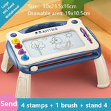 Children's drawing board with stamps and a brush 