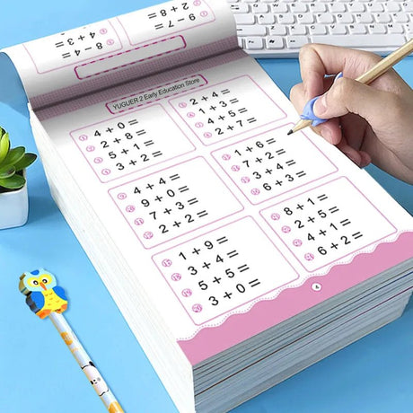 Educational math workbook with a hand holding a pencil on a blue surface