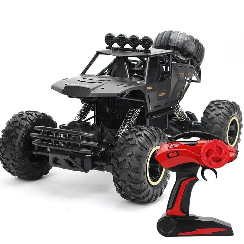 Black remote-control monster truck with large wheels and a red-and-black remote.