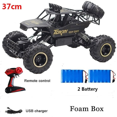 Toy truck with remote control, batteries, and USB charger.