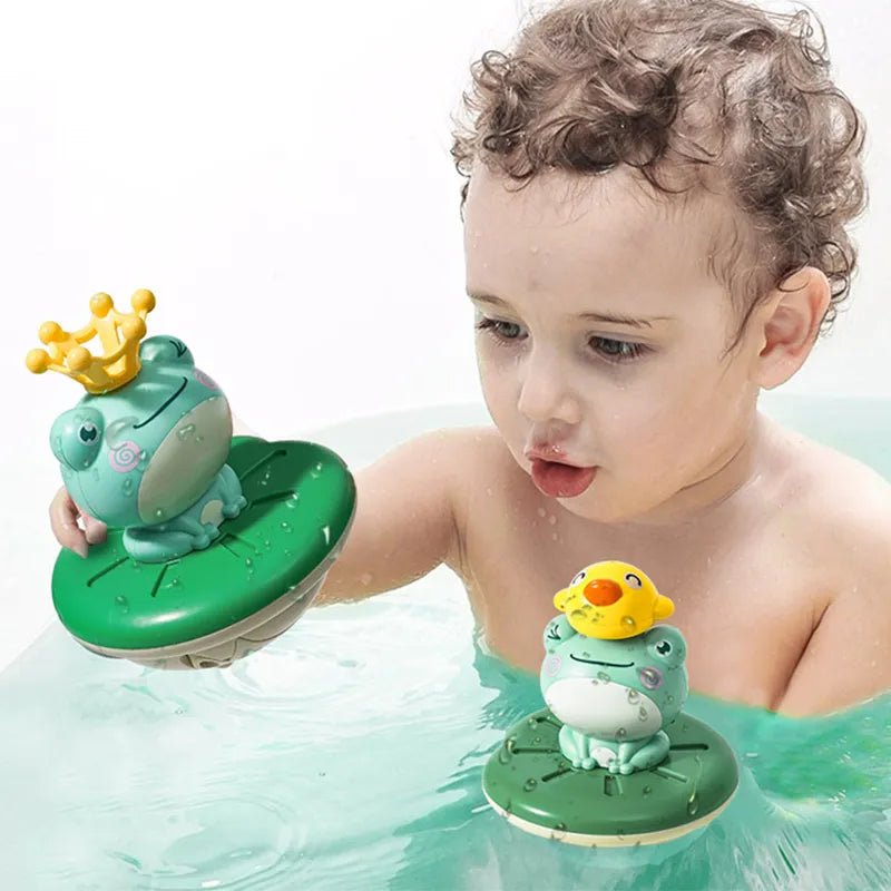 Child playing with frog bath toys in water