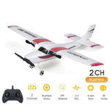 White RC airplane with red accents and a remote control