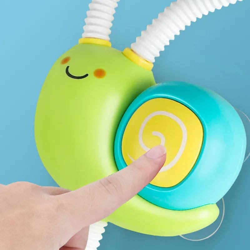 Colorful toy with a smiley face and a hand pressing a button.