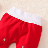Red pants with white snowflake designs 