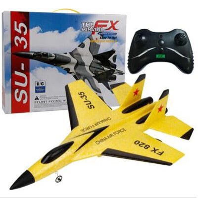Yellow toy airplane with black accents, remote control, and packaging.